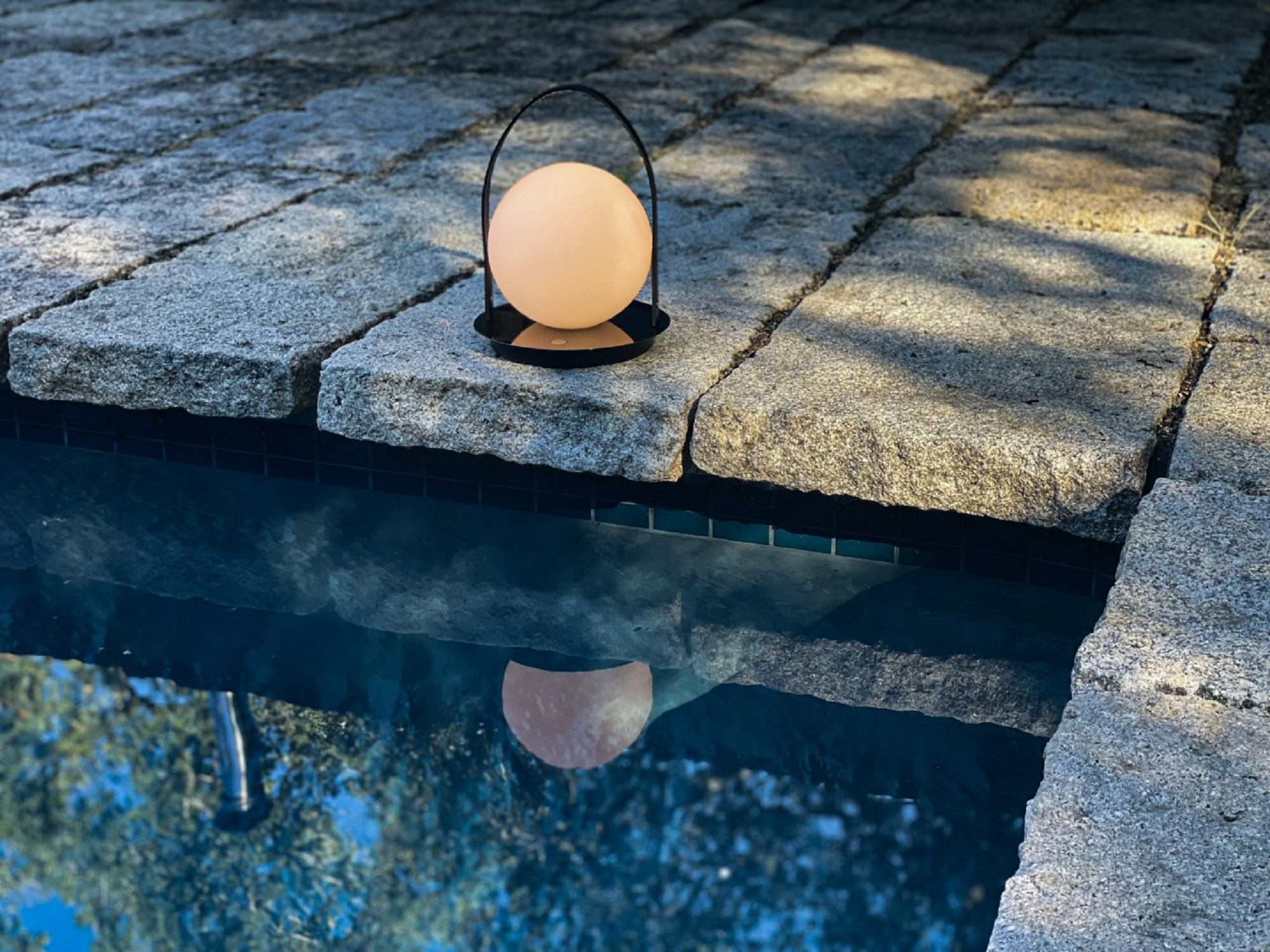 Round outdoor lamp with handle on edge of dock